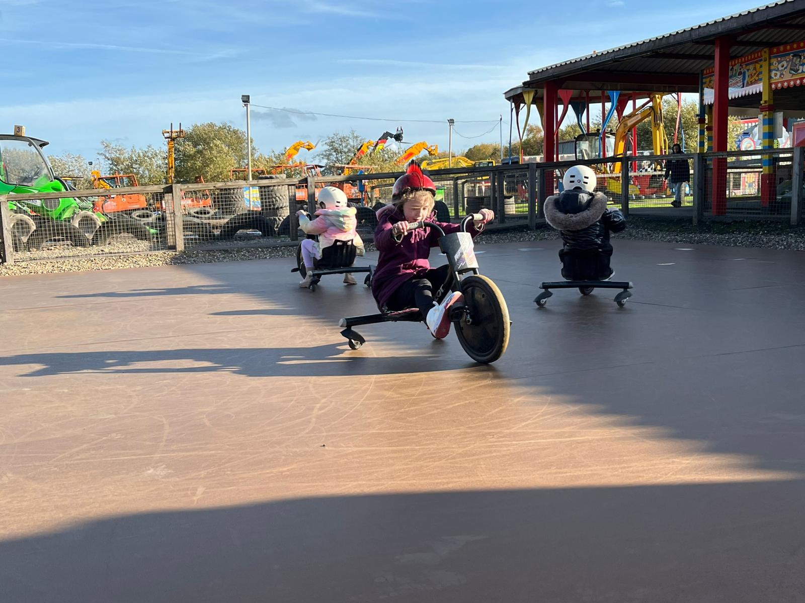 Crazy Trikes Ride at Diggerland UK Theme Park Children riding black razor trikes