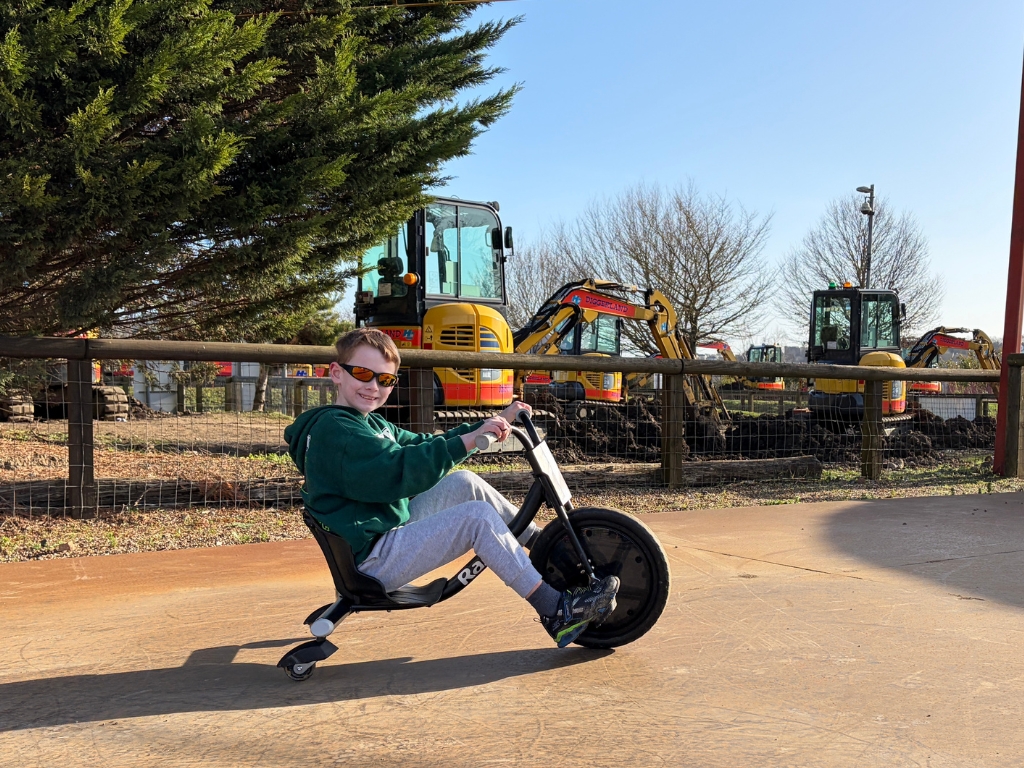 Crazy Trikes Ride at Diggerland UK Theme Park Children riding black razor trikes